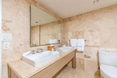 a bathroom with a sink and a toilet and a mirror at Oceanfront Private Condo at 1 Hotel & Homes -1019 in Miami Beach
