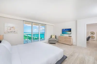 a white bedroom with a large bed and a large window at Oceanfront Private Condo at 1 Hotel & Homes -1019 in Miami Beach