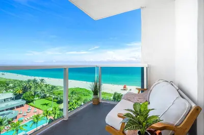 a room with a balcony with a view of the ocean at Oceanfront Private Condo at 1 Hotel & Homes -1019 in Miami Beach