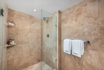 a bathroom with a shower with a glass door at Oceanview Private Condo at 1 Hotel & Homes -1408 in Miami Beach