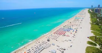 an overhead view of a beach with umbrellas and the ocean at Oceanview Private Condo at 1 Hotel & Homes -1106 in Miami Beach