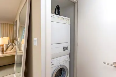 a laundry room with a washing machine and a mirror at Oceanview Private Condo at 1 Hotel & Homes -1106 in Miami Beach