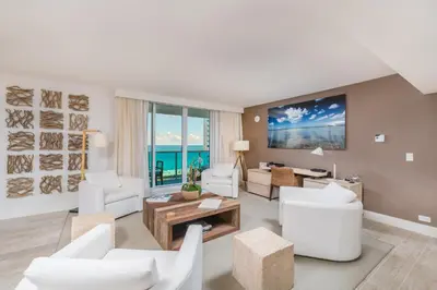 a living room with white furniture and a view of the ocean at Oceanview Private Condo at 1 Hotel & Homes -1040 in Miami Beach