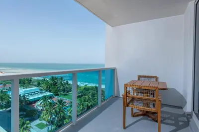 a room with a balcony with a view of the ocean at Oceanview Private Condo at 1 Hotel & Homes -1015 in Miami Beach
