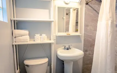 a bathroom with a sink and a toilet and a mirror at Up Midtown in Miami
