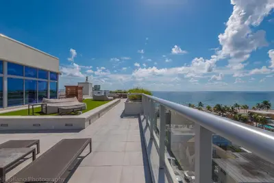 a balcony with a view of the ocean at CH Luxury Condos & Studios On The Beach in Hollywood