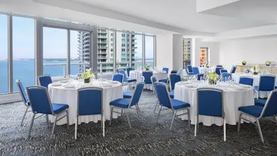 a conference room with tables and chairs and the ocean at Hyatt Centric Brickell Miami in Miami