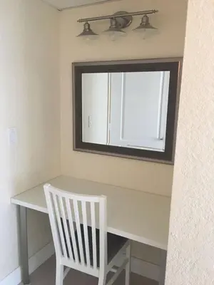 a white table with a white chair and a mirror at Ocean Reserve Piso 4 STR264 in Miami Beach