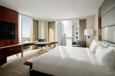 a hotel room with a large white bed and a desk at JW Marriott Marquis Miami in Miami