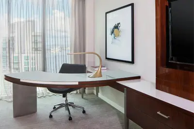a desk with a chair and a television in a room at JW Marriott Marquis Miami in Miami
