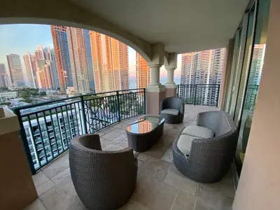 a balcony with chairs and a view of a city at The King David Condos in Miami Beach