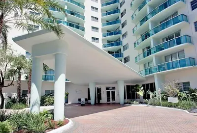 a large white building with palm trees in front of it at THE TIDES 2 bedrooms 9th floor WE ARE ON THE BEACH! in Hollywood