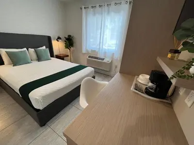 a bedroom with a large bed and a table with a table at Costa Norte Boutique Hotel Miami Beach in Miami Beach