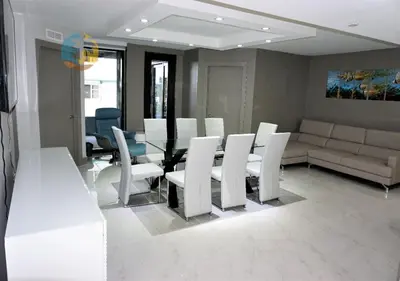 a living room with a table and white chairs at Luxury Beach Resort - HORA RENTALS in Miami Beach