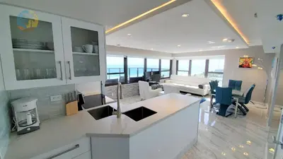 a kitchen and living room with a view of the ocean at Luxury Beach Resort - HORA RENTALS in Miami Beach
