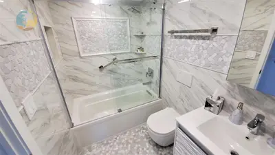 a bathroom with a shower and a toilet and a sink at Luxury Beach Resort - HORA RENTALS in Miami Beach
