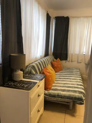 a small room with a couch with pillows on it at Hollywood Beachfront House in Hollywood