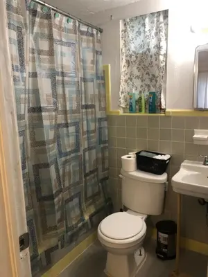 a bathroom with a toilet and a sink at Hollywood Beachfront House in Hollywood