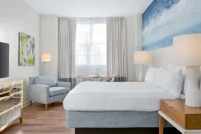 a hotel room with a large bed and a chair at Marriott Vacation Club, South Beach in Miami Beach