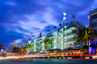 a building with palm trees in front of it at Bentley Hotel South Beach in Miami Beach