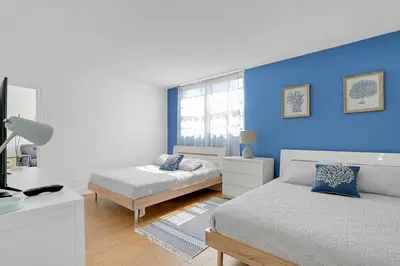 a bedroom with two beds and a blue wall at 2 BEDROOMS 2 FULL BATHROOMS APT. ON THE BEACH in Hollywood