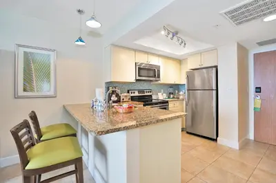 a kitchen with a counter and a stainless steel refrigerator at Hollywood Beach Tower in Hollywood