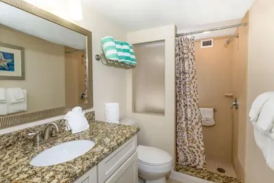 a bathroom with a sink and a toilet and a mirror at Hollywood Beach Tower in Hollywood