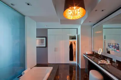 a bathroom with a tub and a sink and a mirror at Hotel Beaux Arts, Autograph Collection in Miami