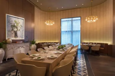 a dining room with a long table and chairs and lights at Hotel Beaux Arts, Autograph Collection in Miami