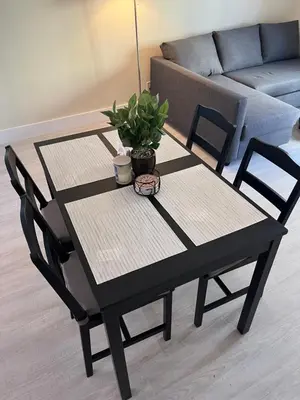a black table with two chairs and a plant on it at King condo Fort Lauderdale Central beach in Fort Lauderdale