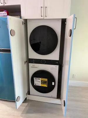 a microwave inside of a cabinet with its door open at King condo Fort Lauderdale Central beach in Fort Lauderdale