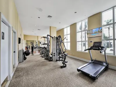 a gym with treadmills and ellipticals in a building at King David Condominium Sunny Isles Beach in Miami Beach
