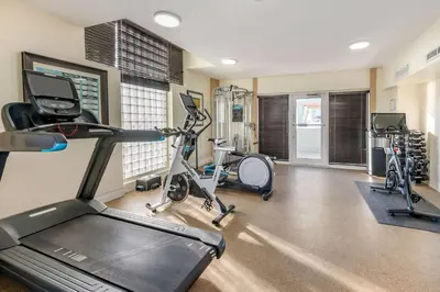 a gym with treadmills and elliptical machines at Hilton Grand Vacations Club Mcalpin Ocean Plaza Miami in Miami Beach