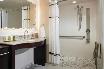 a bathroom with a sink and a shower at Hilton Grand Vacations Club Mcalpin Ocean Plaza Miami in Miami Beach