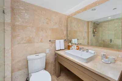 a bathroom with a toilet and a sink and a mirror at Oceanview Private Condo at 1 Hotel & Homes -1122 in Miami Beach