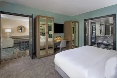 a bedroom with a bed and a living room at W Miami in Miami