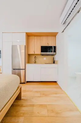 a kitchen with a bed and a sink and a microwave at Green Island Inn in Fort Lauderdale