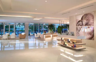 a lobby with couches and chairs in a building at Grand Beach Hotel Bay Harbor in Miami Beach