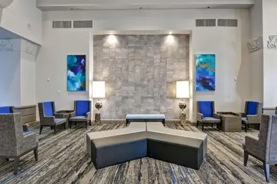 a waiting room at a hospital with chairs and a table at Embassy Suites by Hilton Miami International Airport in Miami