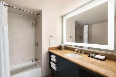 a bathroom with a sink and a mirror at Embassy Suites by Hilton Miami International Airport in Miami