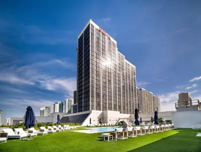 a rendering of a building with a pool and chairs at Hilton Miami Downtown in Miami
