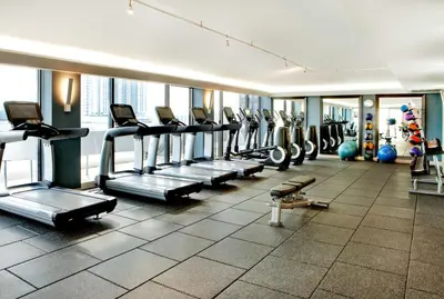 a gym with a row of treadms and machines at Hilton Miami Downtown in Miami