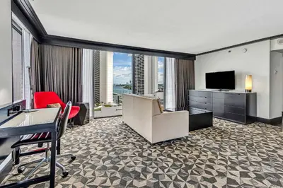 a hotel room with a desk and a television at Hilton Miami Downtown in Miami