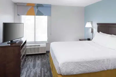 a hotel room with a bed and a flat screen tv at Hampton Inn & Suites Miami-Doral Dolphin Mall in Miami