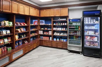 a grocery store aisle with a refrigerator and food at Hampton Inn & Suites Miami-Doral Dolphin Mall in Miami