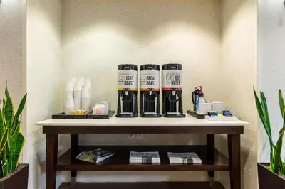 a table in a room with a shelf withanism at Hampton Inn & Suites Miami Airport South/Blue Lagoon in Miami
