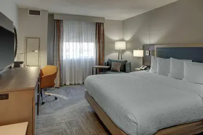 a hotel room with a bed and a television at Hampton Inn & Suites Miami Airport South/Blue Lagoon in Miami