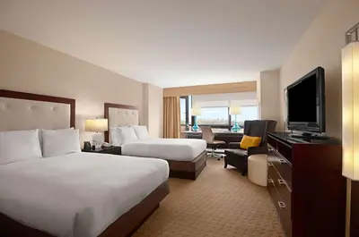 a hotel room with two beds and a flat screen tv at Hilton Miami Airport Blue Lagoon in Miami