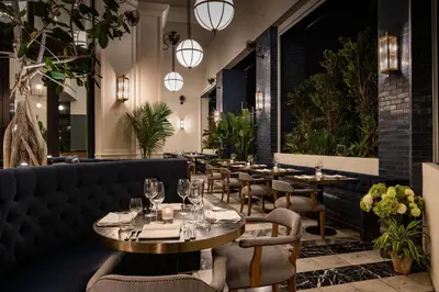 a restaurant with tables and chairs and lights at Element Fort Lauderdale Downtown in Fort Lauderdale