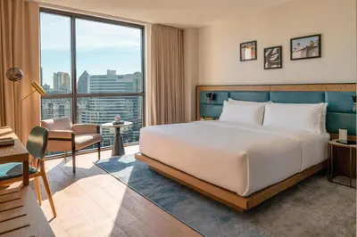 a hotel room with a bed and a large window at The Dalmar, Fort Lauderdale, a Tribute Portfolio Hotel in Fort Lauderdale